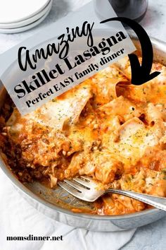 a close up of a plate of food with a fork in it and the words amazing skillet lasagna