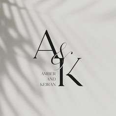 the logo for amber and kieran is shown in black on a white background with long shadows