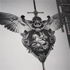 an ornate clock with two wings on it