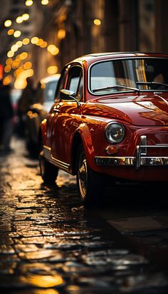 an old red car is parked on the street