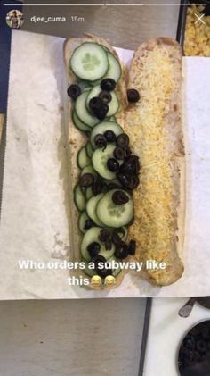 a sandwich with cucumbers and black olives on it