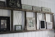 a shelf filled with pictures and framed photos