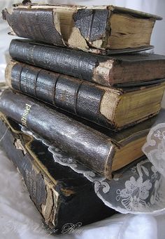 four old books stacked on top of each other