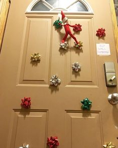 the door is decorated with christmas decorations and elf's hands on top of it