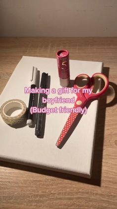 a book with writing on it sitting on top of a table next to some lipstick