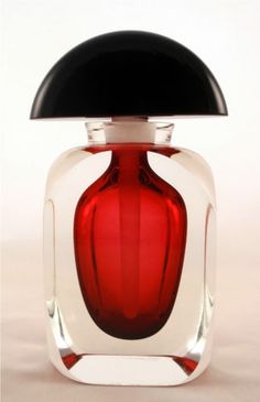 a red glass bottle with a black top on a white background, in the shape of a vase