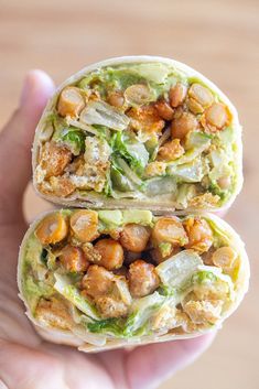 two wraps filled with meat, lettuce and chickpeas on top of each other