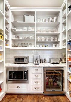 a kitchen with white cabinets and open shelving