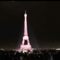 the eiffel tower is lit up in pink