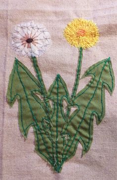 a close up of a piece of cloth with two flowers on it and one flower in the middle