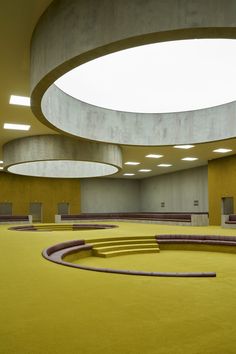 an empty room with circular lights and yellow carpet