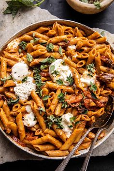 a skillet filled with pasta and sauce