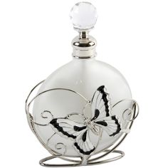 a white glass bottle with a butterfly on it's top and a metal stand