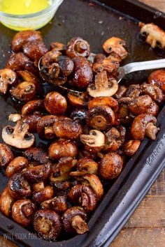 mushrooms on a baking sheet with a spoon