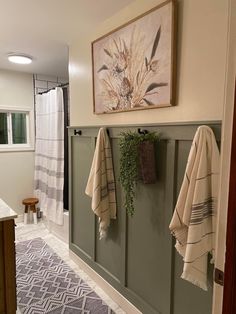 a bathroom with towels hanging on the wall