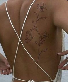 the back of a woman's body with flowers on it