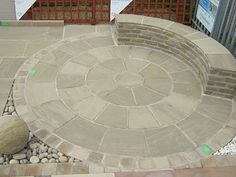 a stone fire pit surrounded by rocks and gravel