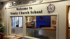 there is a sign that says trinity church school on the front wall and windows in the back