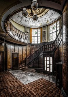 an old building with a staircase and chandelier