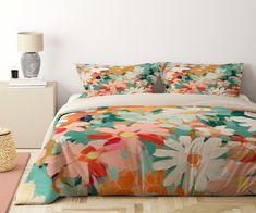 a bed with colorful flowers on it in a room