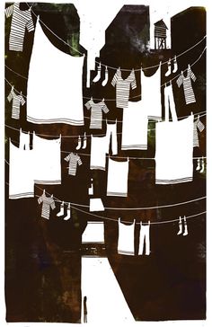 clothes hanging out to dry on a line with buildings and water tower in the background