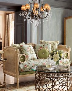 a living room filled with furniture and a chandelier