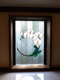 a stained glass window with white flowers on it