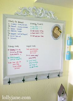 a dry erase board mounted to the side of a wall with magnets on it