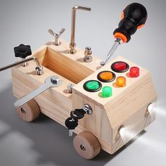 a wooden toy car with buttons and tools on the front, attached to it's wheels