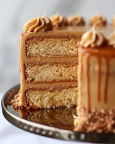 a slice of cake on a plate with the rest of the cake in the background