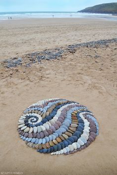 a circle made out of rocks on the beach