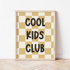 a poster with the words cool kids club in black and yellow on it, against a white wall