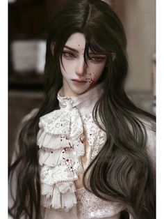 a woman with long black hair and blood on her face is wearing a white blouse