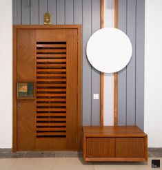 a room with a wooden door and a white disk on the wall