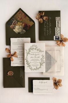 the wedding stationery is laid out on top of each other