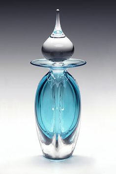 a blue glass vase sitting on top of a table