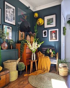 a living room filled with lots of plants and pictures