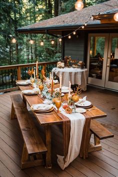 a wooden table topped with plates and candles