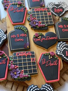 decorated cookies are arranged on a wooden platter