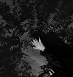 a person is reaching for something in the water