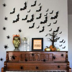 a piano with bats on the wall above it