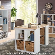 a desk with baskets and books on it next to a window in a living room