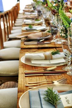 a long table set with place settings and napkins