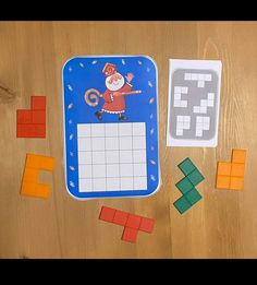 a wooden table topped with lots of different colored blocks and magnets on top of it