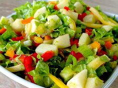 a close up of a salad in a bowl on a table