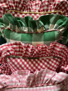 four pillows stacked on top of each other with ruffles at the bottom and sides