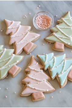 decorated christmas trees and cookies on a table