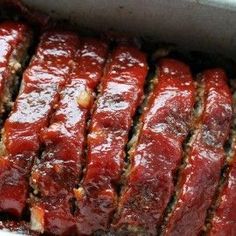 the meatloaf is covered in sauce and ready to be cooked on the grill