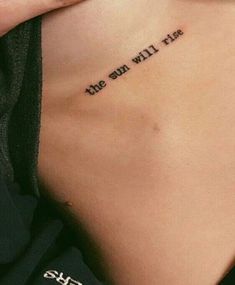 the back of a woman's chest with an inscription on it that says, the sun will rise