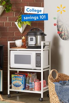 a microwave oven sitting on top of a white shelf next to a basket filled with food